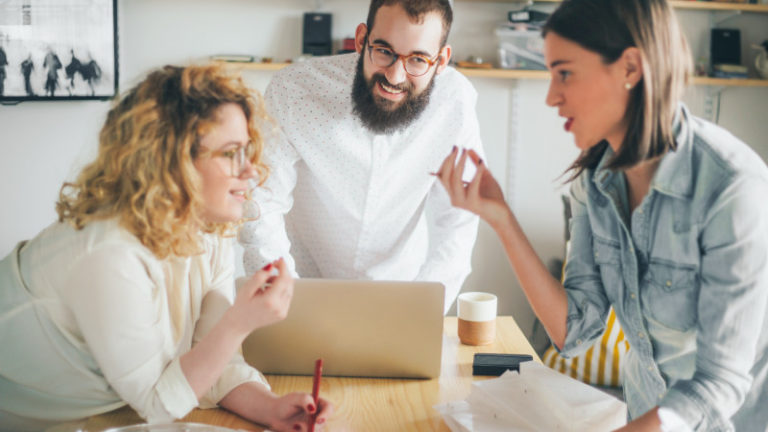 Coworkers collaborating over workspace featured image