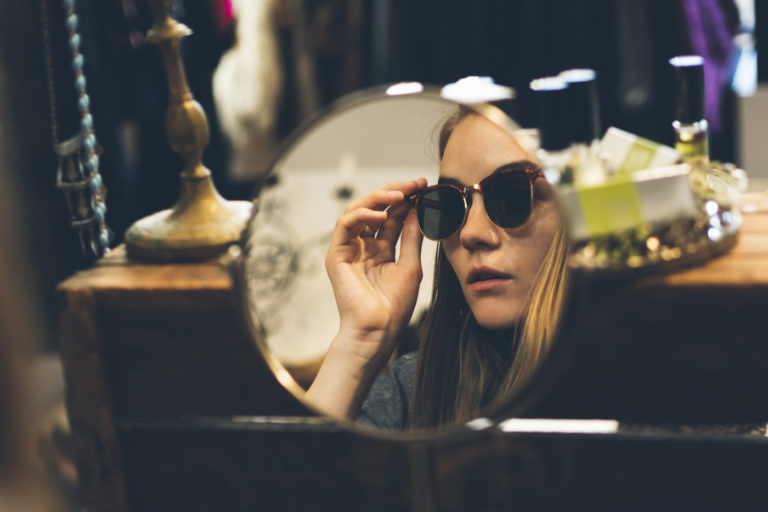 Shopper trying on sunglasses featured image